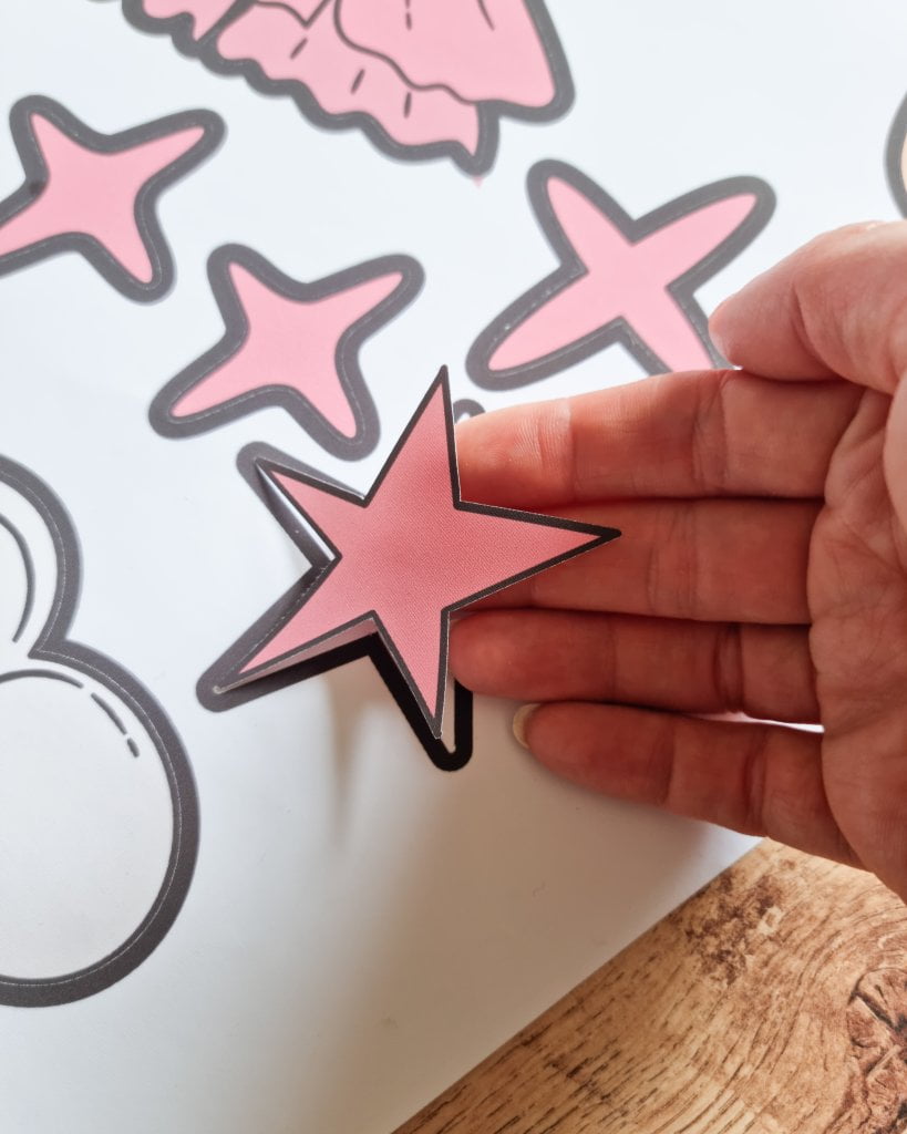 Stickerele sunt taiate pe contur. Mana tinand un autocolant